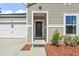 Close up of front entry featuring neutral siding, and nicely landscaped entry way at 751 Dusty Pine Way, Myrtle Beach, SC 29588