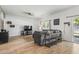 Living room featuring wood floors, ceiling fan, modern decor, and sliding glass doors to fenced yard at 751 Dusty Pine Way, Myrtle Beach, SC 29588