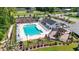 Aerial view of community pool and playground featuring lounge chairs, picnic tables, and manicured landscaping at 751 Dusty Pine Way, Myrtle Beach, SC 29588
