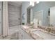 Bright bathroom featuring a double granite vanity, tile flooring, a bathtub with shower, and an elegant neutral color palette at 812 Maltby Alley, Myrtle Beach, SC 29588