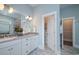 Modern bathroom featuring double vanities, granite countertops, and a walk-in closet at 812 Maltby Alley, Myrtle Beach, SC 29588