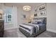Bright bedroom with surfing-themed decor, a patterned bedframe, and a striped comforter with plenty of natural light at 812 Maltby Alley, Myrtle Beach, SC 29588