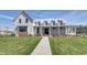 Charming two-story home with a metal roof, a welcoming front porch, and a well-maintained lawn and landscaping at 812 Maltby Alley, Myrtle Beach, SC 29588