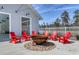 Outdoor area with red Adirondack chairs around a fire pit, perfect for socializing and enjoying the outdoors at 812 Maltby Alley, Myrtle Beach, SC 29588