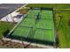 Aerial view of community pickleball courts featuring green surfaces, black fencing, shaded seating, and organized layout at 812 Maltby Alley, Myrtle Beach, SC 29588