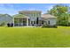 Expansive backyard with a screened-in porch, patio seating, and a built-in fire pit area at 818 Mourning Dove Dr., Myrtle Beach, SC 29577