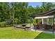 Relaxing backyard patio featuring a swing bench, seating, fire pit, and lush green lawn at 818 Mourning Dove Dr., Myrtle Beach, SC 29577