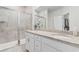 Bright bathroom with a double vanity, granite countertop, glass shower, and neutral tile at 818 Mourning Dove Dr., Myrtle Beach, SC 29577