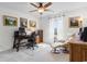 Sunlit bedroom featuring a wooden desk, computer, and comfortable seating with a view from the window at 818 Mourning Dove Dr., Myrtle Beach, SC 29577