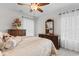 Bedroom with neutral tones featuring a large bed, dresser, and natural light from the window at 818 Mourning Dove Dr., Myrtle Beach, SC 29577