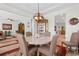 Charming dining room with a round table, upholstered chairs, and elegant light fixture at 818 Mourning Dove Dr., Myrtle Beach, SC 29577