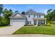 Charming two-story home with light blue siding, a two-car garage, and a well-maintained front yard at 818 Mourning Dove Dr., Myrtle Beach, SC 29577