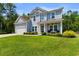 Charming two-story home with a well-manicured lawn and inviting front porch, perfect for relaxing at 818 Mourning Dove Dr., Myrtle Beach, SC 29577
