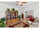 Bright living room featuring hardwood floors, large bookcases, and a glimpse into the dining area at 818 Mourning Dove Dr., Myrtle Beach, SC 29577