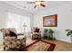 Living room with two armchairs, hardwood floors, and large windows with natural light at 818 Mourning Dove Dr., Myrtle Beach, SC 29577