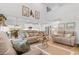 Bright living room with high ceilings, comfortable seating, and an open floor plan to the kitchen and dining area at 818 Mourning Dove Dr., Myrtle Beach, SC 29577