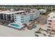Aerial view of a blue condo building with a pool and beach access at 824 N Waccamaw Dr. # 204, Murrells Inlet, SC 29576