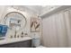 Bathroom with modern vanity, round mirror and shower at 824 N Waccamaw Dr. # 204, Murrells Inlet, SC 29576