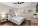 Bedroom featuring a bed with modern decor, ceiling fan and accent wall at 824 N Waccamaw Dr. # 204, Murrells Inlet, SC 29576