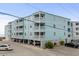 Three story condo building featuring light blue siding and white railings and trim at 824 N Waccamaw Dr. # 204, Murrells Inlet, SC 29576