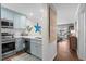 Galley kitchen with stainless steel appliances and coastal blue cabinets at 824 N Waccamaw Dr. # 204, Murrells Inlet, SC 29576