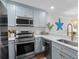 Kitchen featuring stainless appliances, tile backsplash, and quartz countertops at 824 N Waccamaw Dr. # 204, Murrells Inlet, SC 29576
