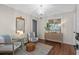 Cozy sitting area with wainscotting, wood-look flooring, and stylish decor at 824 N Waccamaw Dr. # 204, Murrells Inlet, SC 29576