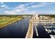 Aerial view showcasing waterfront condos, a marina filled with boats, and lush greenery along the shoreline at 8323 Cape Dutch Loop, Myrtle Beach, SC 29572