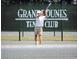 Action shot of a tennis player on the court at Grand Dunes Tennis Club at 8323 Cape Dutch Loop, Myrtle Beach, SC 29572