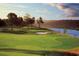 Scenic golf course with lush green fairways, a sand trap, and a picturesque water view in the background at 8352 Cape Dutch Loop, Myrtle Beach, SC 29572