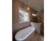 Bathroom featuring a soaking tub, patterned tile accents, and a glass-enclosed shower with marble-style walls at 5009 Middleton Dr., Myrtle Beach, SC 29579