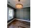 A dining room with beautiful wood floors, decorative molding, contemporary lighting, and a large window at 5009 Middleton Dr., Myrtle Beach, SC 29579