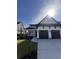 Stunning two-story home featuring a three-car garage, landscaped yard, and charming front porch at 5009 Middleton Dr., Myrtle Beach, SC 29579