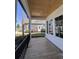 Inviting covered front porch featuring wood-look flooring and stylish black railings at 5009 Middleton Dr., Myrtle Beach, SC 29579