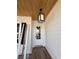 Welcoming front porch features stylish overhead light fixture and wood-look flooring at 5009 Middleton Dr., Myrtle Beach, SC 29579