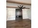 Living room with hardwood floors, fireplace with wood mantel, built-in shelving, and modern ceiling fan at 5009 Middleton Dr., Myrtle Beach, SC 29579