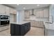 Modern kitchen boasts stainless appliances, light grey countertops, and a dark island at 905 Monmouth Dr., Myrtle Beach, SC 29588