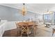 Dining area with wood table and chairs, pendant lighting, and a glimpse into the living room at 917 S Ocean Blvd. # 103, Surfside Beach, SC 29575