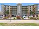 Surf Watch II condo building featuring multiple floors, balconies, landscaping, and parking at 917 S Ocean Blvd. # 103, Surfside Beach, SC 29575