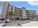 Close up of condo exterior showcasing architectural details, well-kept grounds, and covered parking at 917 S Ocean Blvd. # 103, Surfside Beach, SC 29575