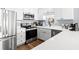 Renovated kitchen with stainless steel appliances, white cabinets, light countertops, and modern fixtures at 917 S Ocean Blvd. # 103, Surfside Beach, SC 29575