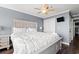 Comfortable main bedroom with king bed, fan, TV, and a small lamp on the nightstand at 917 S Ocean Blvd. # 103, Surfside Beach, SC 29575