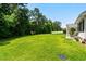 This is a large backyard with luscious green grass and a white fence enclosing the yard at 950 Henry James Dr., Myrtle Beach, SC 29579