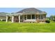 Brick home featuring a screened in porch and pergola in the backyard at 950 Henry James Dr., Myrtle Beach, SC 29579