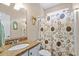 This bathroom features a granite topped vanity and a shower with a decorative curtain at 950 Henry James Dr., Myrtle Beach, SC 29579