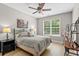 This bedroom has a queen bed, a window with a tree view and stylish decor at 950 Henry James Dr., Myrtle Beach, SC 29579