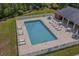 Aerial view of a community pool with lounge chairs, tables, and a fenced perimeter at 950 Henry James Dr., Myrtle Beach, SC 29579
