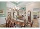 Elegant dining room with hardwood floors, chandelier, and seamless flow into living room at 950 Henry James Dr., Myrtle Beach, SC 29579