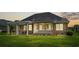 Charming home exterior with screened porch, pergola, and manicured lawn at 950 Henry James Dr., Myrtle Beach, SC 29579