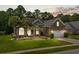 Inviting brick home at twilight with lush lawn, palm trees, and a welcoming two-car garage at 950 Henry James Dr., Myrtle Beach, SC 29579